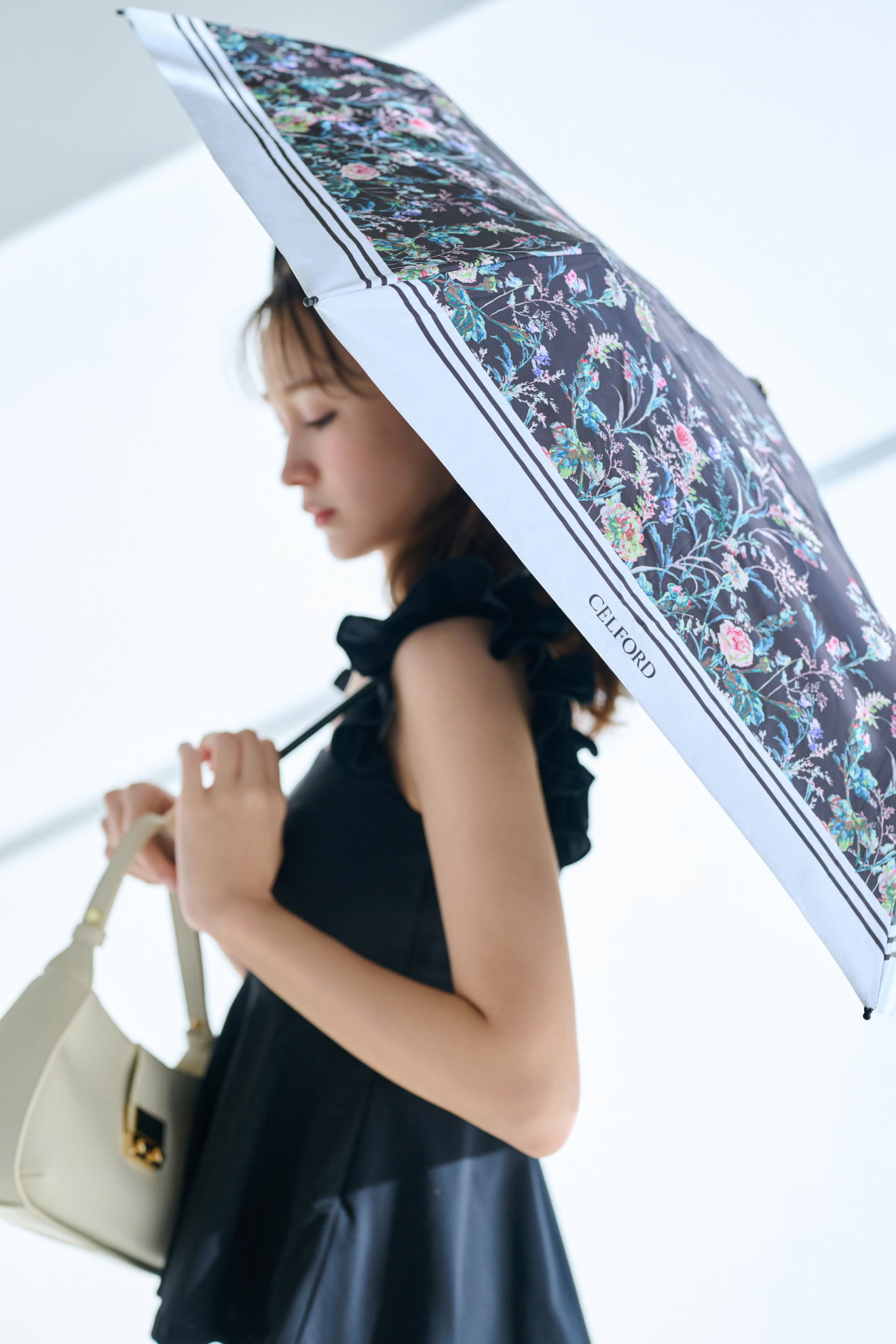 PROTECT Uコラボ日傘、カップインチュニック、2WAYワンハンドルショルダーバッグを着用した女性のイメージ